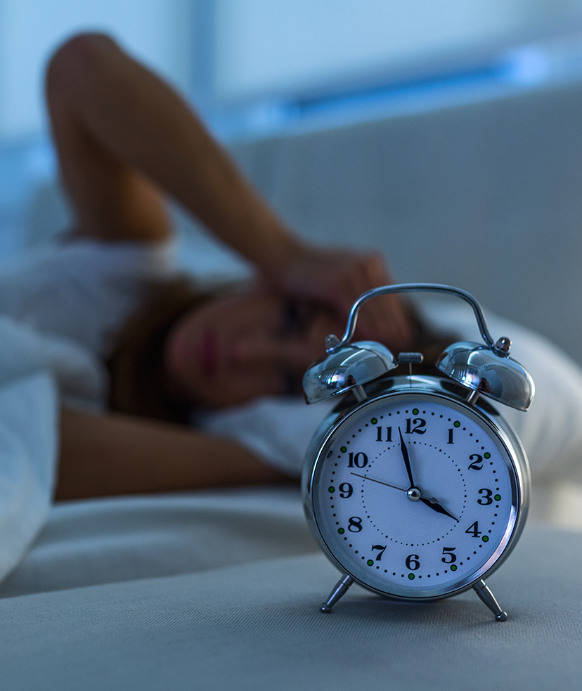 Alarm clock waking a woman up