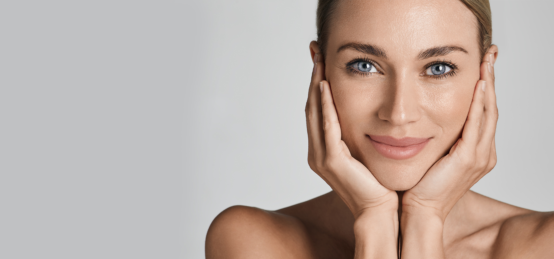 Woman touching her face after microneedling treatments