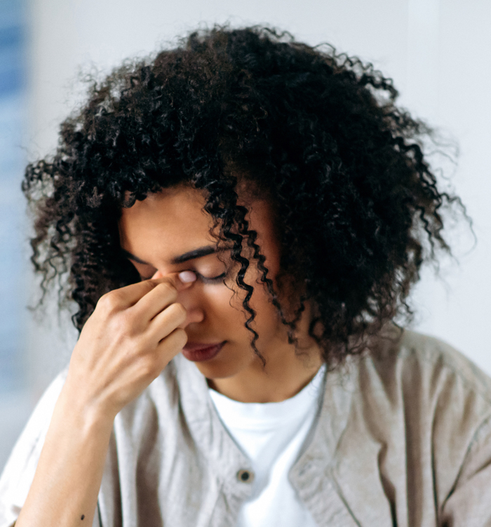 Tired woman with curly hair